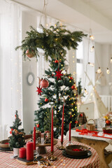 Beautiful table setting for Christmas dinner. Spruce branches with red christmas ornament