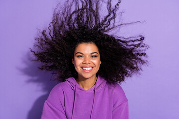 Photo of charming positive lady flying hair toothy smile look camera isolated on purple color background