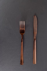 table setting - fork and a knife isolated on black background flat lay