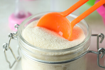 Concept of baby food with рowdered milk close up