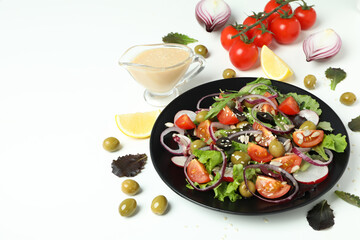 Concept of tasty food with vegetable salad with tahini sauce on white background