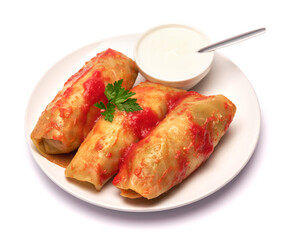 Portion of cabbage rolls stuffed with ground beef and rice with sour cream on a plate