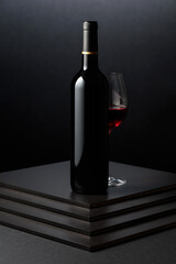 Glass and bottle of red wine.