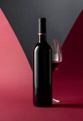 Bottle and glass of red wine.