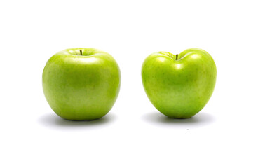 Two green apples, one heart shaped.