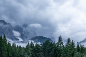 Scenic fog in the Italian Dolomites in the evening after heavy rain