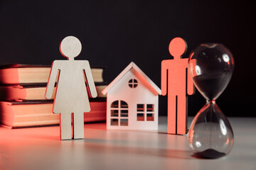 Wooden model of family, house and hourglass. Divorce and divide concept