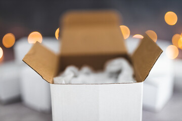 group of delivery parcels with fairy lights in the background, online shopping
