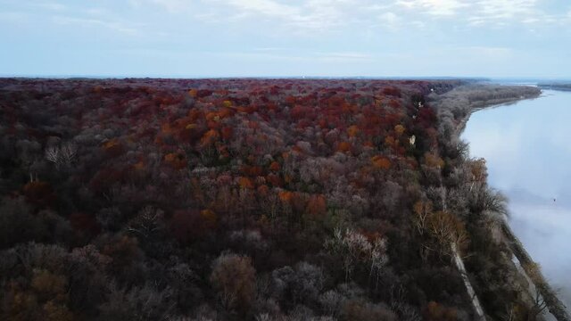 Drone Shot next to the Missouri River. Weldon Spring Lewis and Clark Hiking Trail (Katy Trail). During the autumn season change, red and yellow trees.
