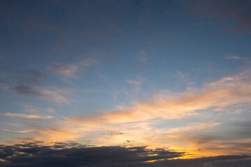 Fototapeta na wymiar Stunning sunset cloudy sky. Low sun illuminates clouds in warm color. Nature background.