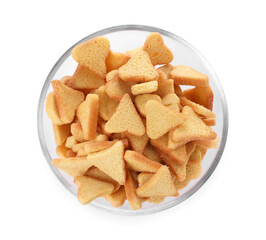 Delicious crispy rusks in glass bowl on white background, top view