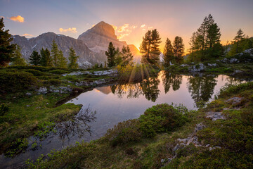 sunrise over pond close to Lago di Limides, Dolomites, Italy