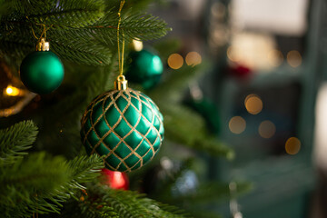 close up of christmas tree with green toy in room