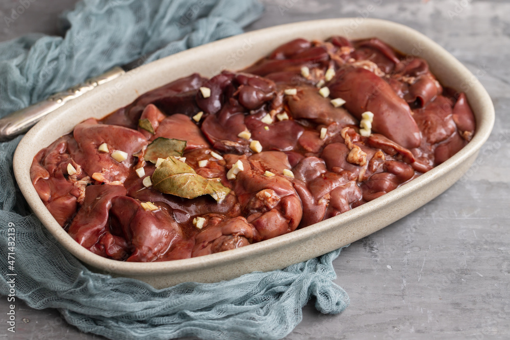 Wall mural chicken liver with bay leaf and marinate on dish