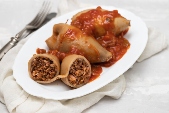 stuffed squids with sauce on white dish