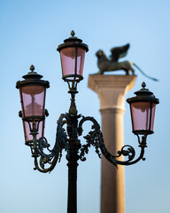 Fototapeta na wymiar Lanterns in front of column with lion in Venice
