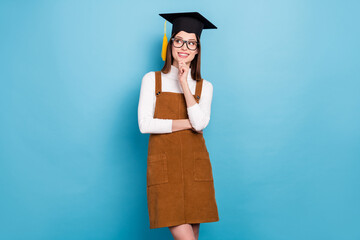 Photo of youth attractive lady arm touch chin look empty space wondered minded isolated over blue...
