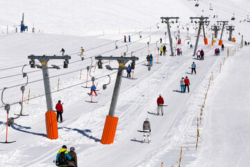 skiers on T-ski lifts, Fiescheralp - ski resort accessible only by cable car from Fiesch, UNESCO...