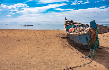 Fishing boat missions on the beach waiting for the next fishing trip. This boat is located on the tropical shore of Keta Ghana West Africa 2021