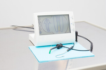 electronic device for the treatment of dental canals in the hands of a dentist in a treatment room....