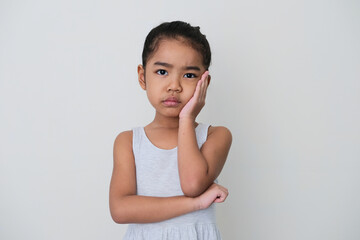 Asian little girl looking forward with boring expression