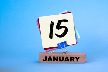 January 15th. Day 15 of month, calendar on blue background. Winter time.