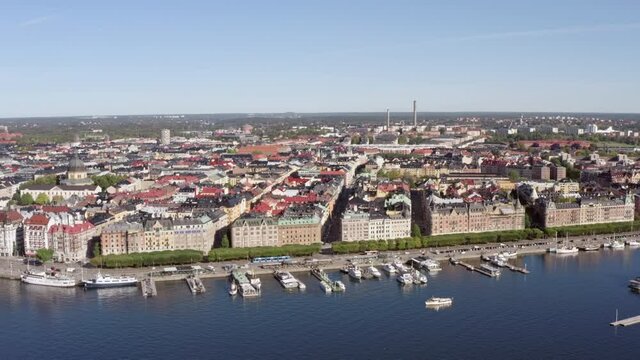 Aerial view urban cityscape of Stockholm. Coastline with berths on which moored boats in the city center with historic buildings.