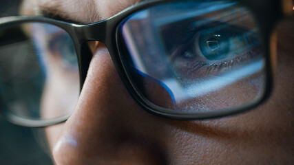 Close-up Portrait of Software Engineer Working on Computer, Line of Code Reflecting in Glasses....