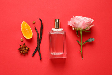 Flat lay composition with bottle of perfume and fresh citrus fruit on red background