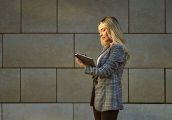 young business woman looking at tablet looking outside