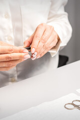 Obraz na płótnie Canvas Professional manicurist preparing tools for doing clients nails