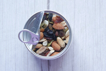 close up of many mixed nuts in a container 