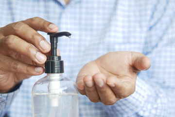 businessman applying sanitizer liquid before using laptop 