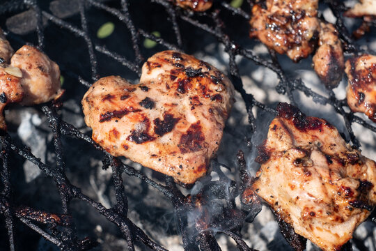 Heart Shaped Piece Of Chicken Meat Cooking On Hot Grill.