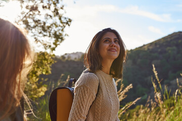 Woman standing on mountain looking up