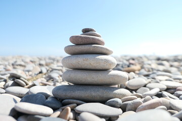 Fototapeta na wymiar Zen rocks pile in a sunny beach in Valencia, Spain