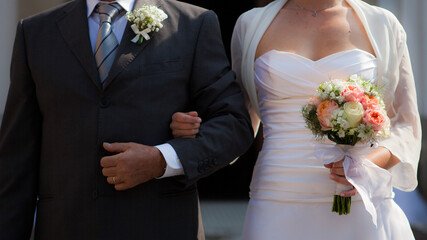 Bride and groom holding standing together close on wedding day outdoors .Togetherness concept