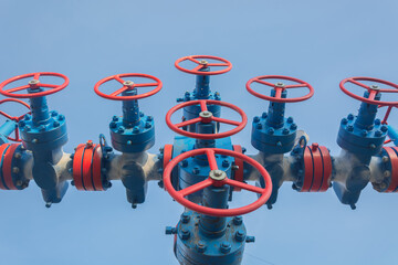 Gas well spout fittings with high-pressure valves and round hand wheels to regulate the flow of gas...