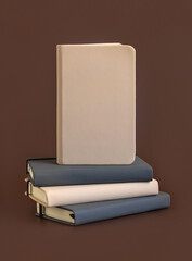 Stack of beige and grey notebooks on brown background closeup