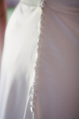 Wedding dress buttons on back side closed glowing background .Wedding dress styles and preparation concept - 471452984