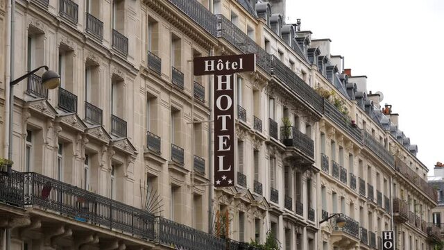 Paris hotel vertical signboard on a building facade in beautiful city center