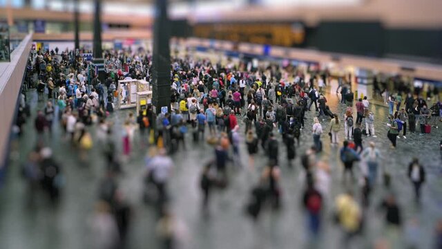 Euston station concourse time lapse with tilt shift miniature effect.
Crowd of people waiting on Euston concourse with a tilt shift miniature differential blur effect.