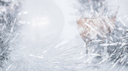 Multiple exposure of a christmas tree ball and two glasses of champagne