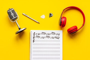 Sheets with music notes and headphones. Compose music concept
