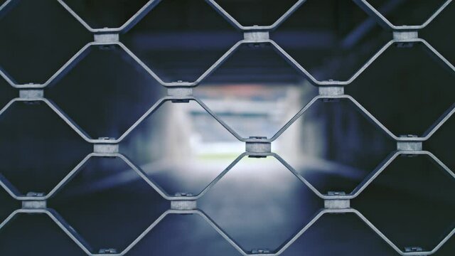 camera moving close on a fence of a closed entrance so a soccer stadium