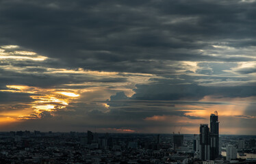Naklejka premium Bangkok, Thailand - Aug 29, 2021 : Gorgeous panorama scenic of the sunrise or sunset with cloud on the orange and blue sky over large metropolitan city in Bangkok. Copy space, No focus, specifically.