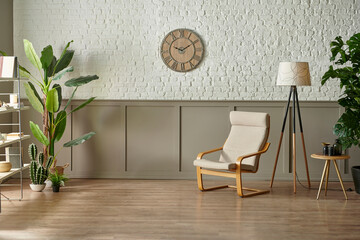 Room wall concept, brick and classic style, clock armchair lamp and green plant botanic interior decor, brown parquet and carpet.