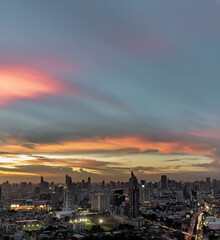 Bangkok, Thailand - Sep 17, 2021 : Aerial view of Beautiful sunset over large metropol city in Asia. With tall building and skyscraper in background. Monotone, No focus, specifically.