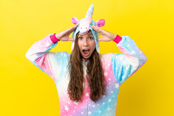 Girl with unicorn pajamas over isolated background with surprise expression