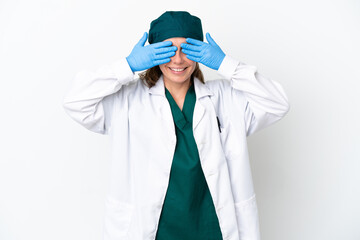 Surgeon caucasian woman in green uniform isolated on white background covering eyes by hands
